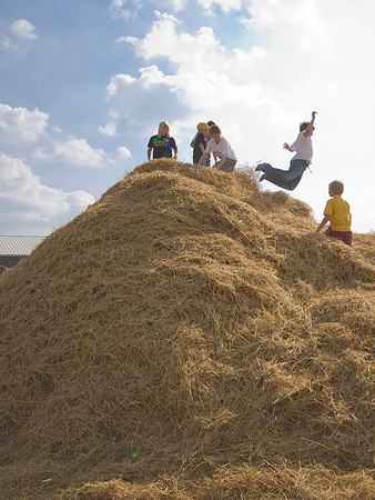Kids Playing On Haystack