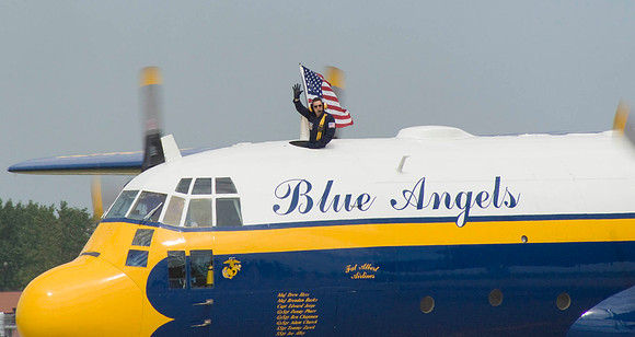 Crewmen Waves From Fat Albert's Top Porthole
