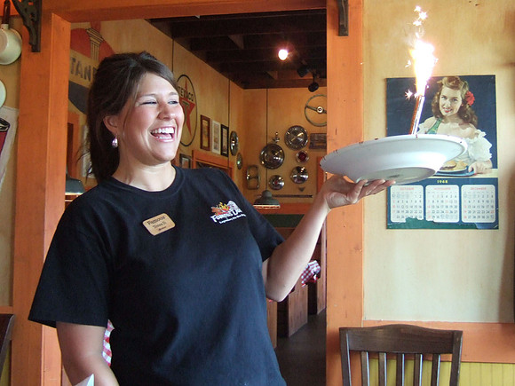 The waitress brings out my free sundae with a sparkler.